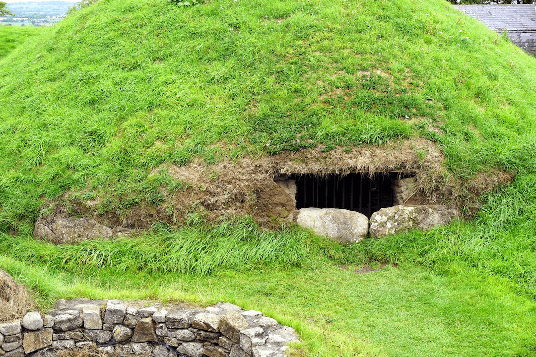Ancient Irish tomb at Dowth neolithic site entrance, overgrown.