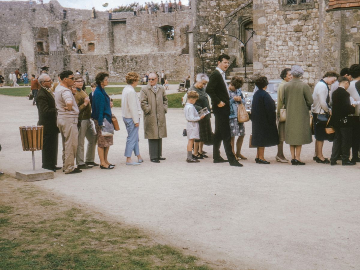 group of people standing on green grass field during daytime